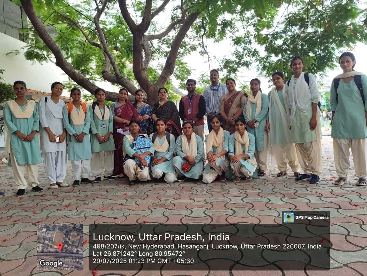 A large group of students and facilitators posing outdoors under a tree after an AI literacy session in Lucknow, Uttar Pradesh.
