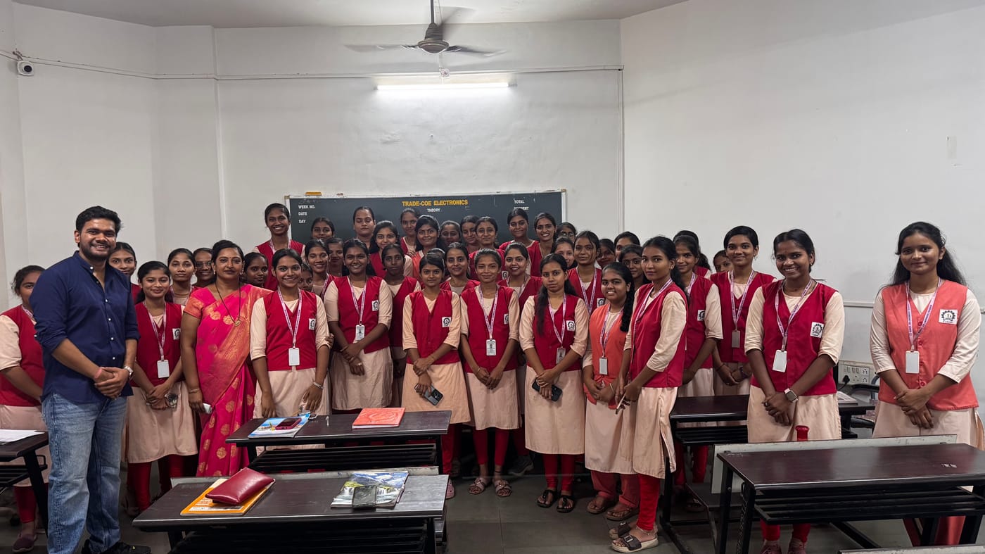 A large group of students in uniform posing with a facilitator after an AI literacy session at a government ITI.
