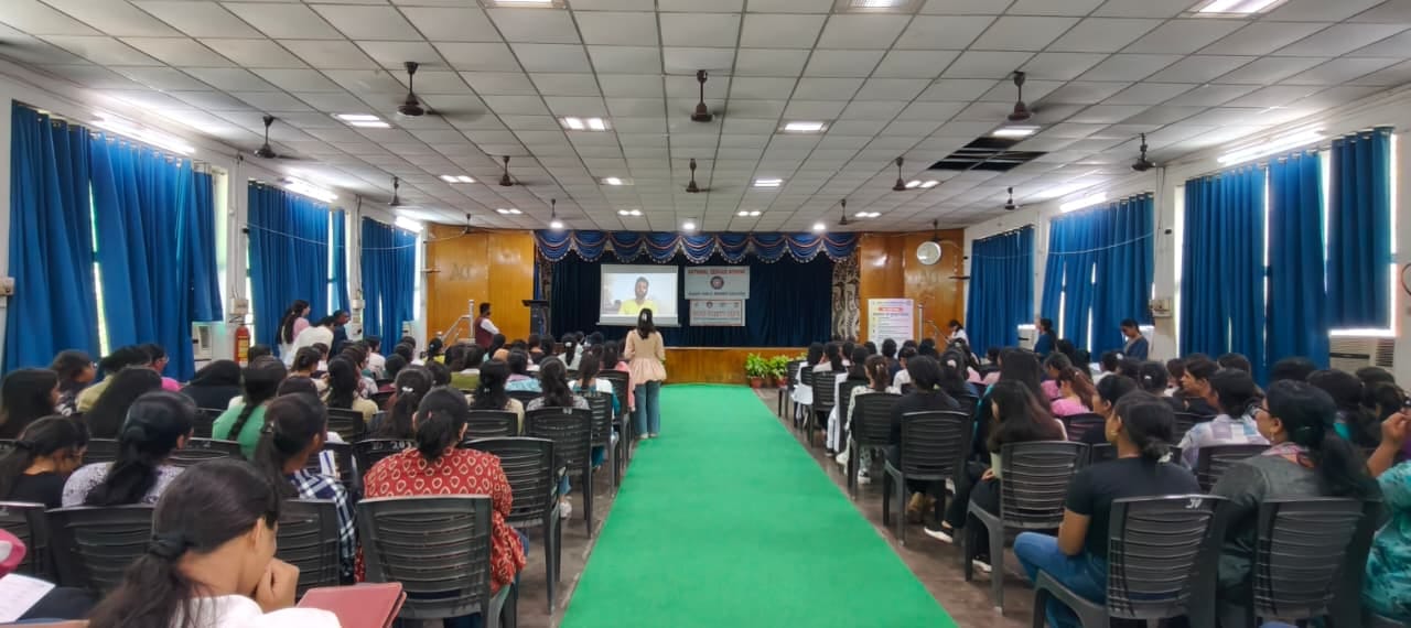 Students seated in a curtained auditorium watching a presentation during an AI literacy session in Lucknow, Uttar Pradesh.