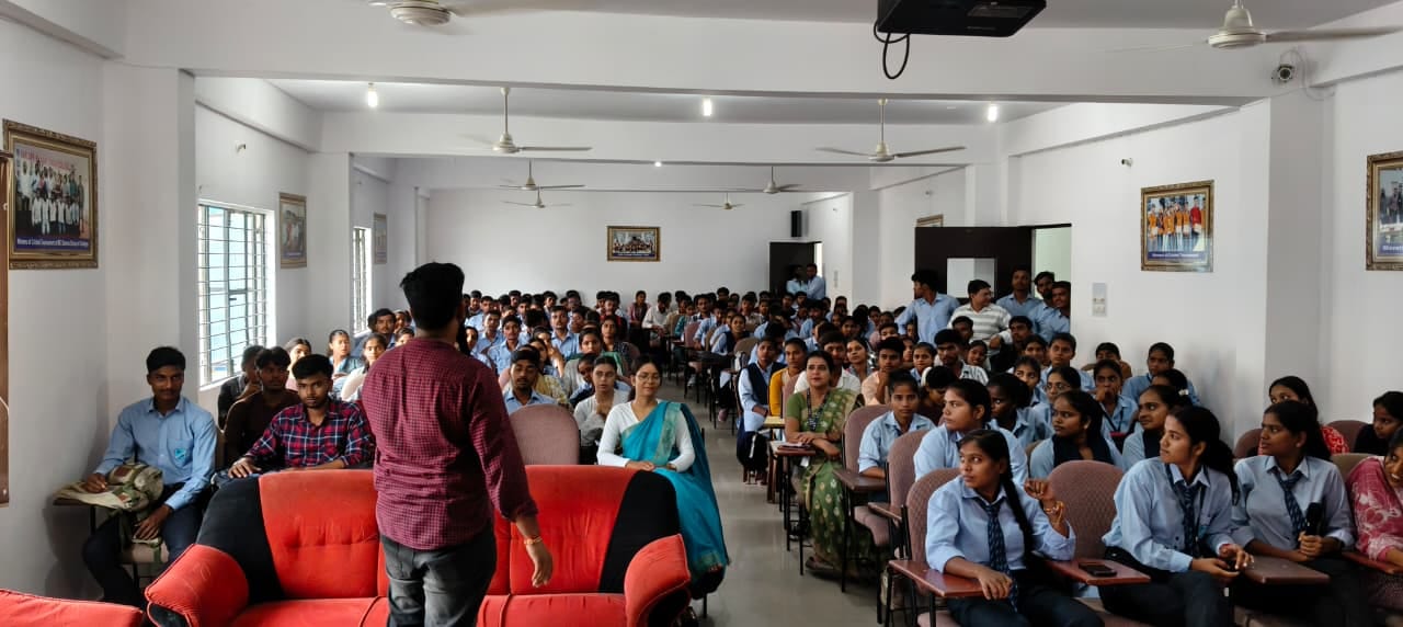 Students seated in a college auditorium during an AI readiness awareness session, facilitator addressing the room.